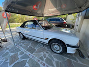 Jante BBS RZ 15 pouces montée sur BMW E30 avec cache moyeu logo BMW visible quartier avant